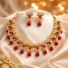 Traditional kundan necklace set with red stones and pearls on golden fabric luxury background bridal wedding jewellery set
