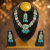 Turquoise stone bridal jewellery set with necklace, earrings and maang tikka on black display, premium festive design for women